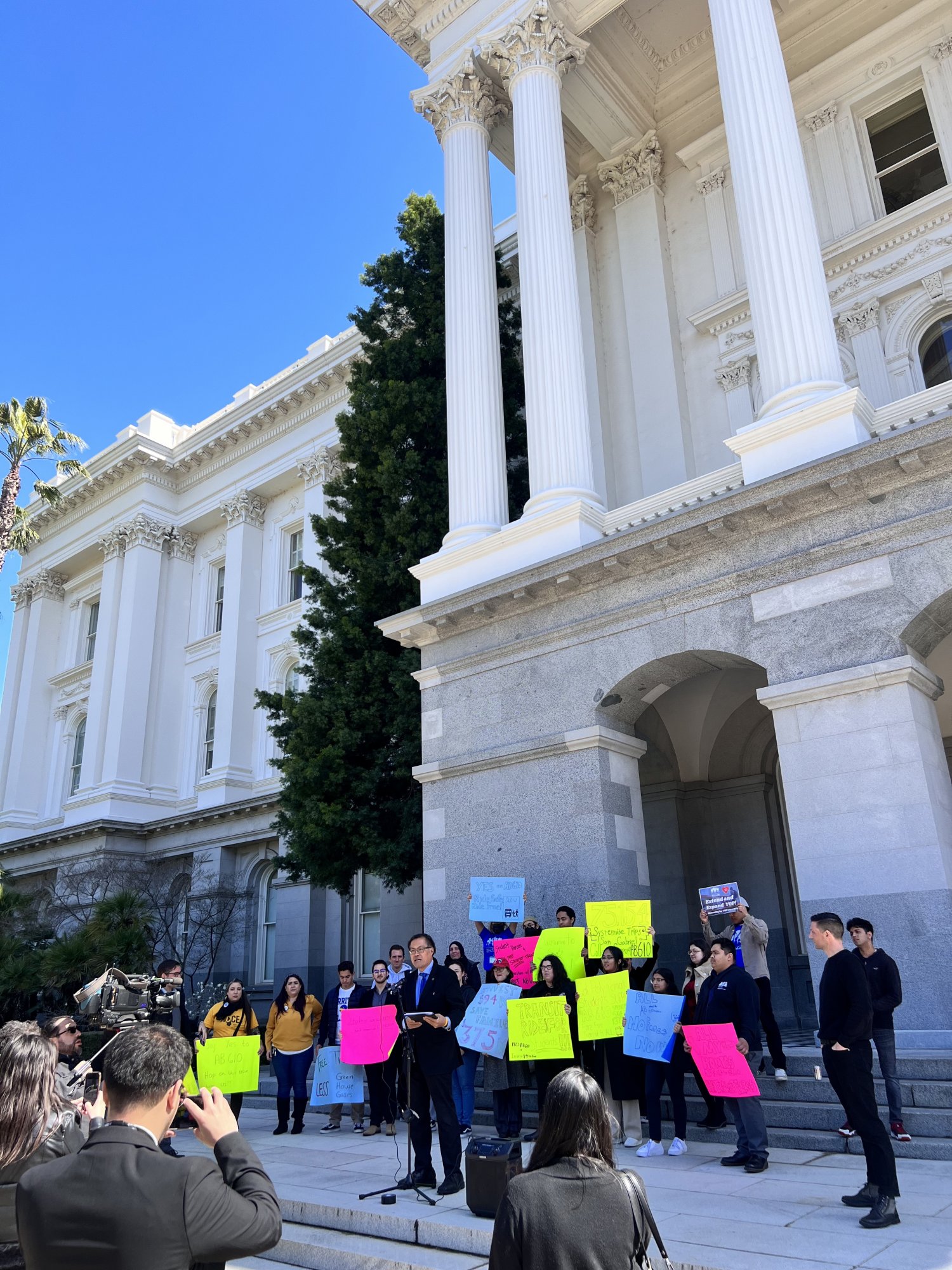 Crowd of people with lobbying signs in front of the California Capitol